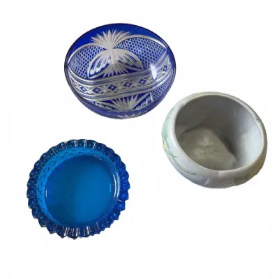 Sale Photo Thumbnail #291: Trio of vintage small glass and ceramic items, including a cobalt cut-to-clear crystal bowl, a blue pressed glass dish with ruffled edge, and a small floral-painted porcelain planter.