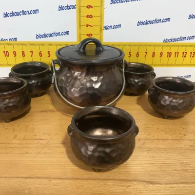 Sale Photo Thumbnail #122: Vintage dark metallic glaze cauldron-style punch or condiment set, featuring a larger covered pot with wire handle and five matching miniature footed cups with hammered texture.