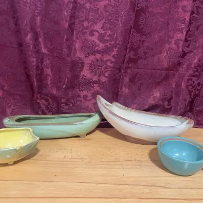 Sale Photo Thumbnail #134: Collection of four mid-century vintage ceramic planters and dishes in organic, asymmetrical shapes, featuring shades of green, yellow, white, and teal.