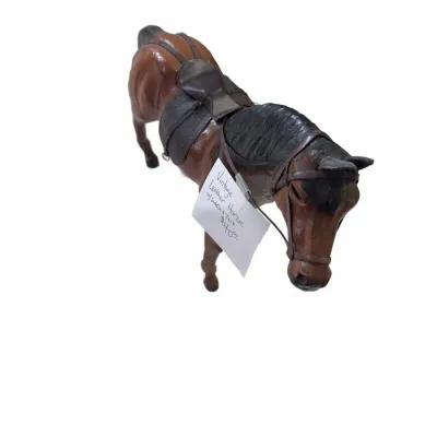 Sale Photo Thumbnail #281: Vintage leather-wrapped horse statuette featuring a detailed saddle and tack harness.