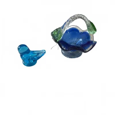 Sale Photo Thumbnail #293: Pair of vintage art glass items, including a light blue glass bird figurine and a cobalt blue ruffled glass basket with a clear twisted handle.
