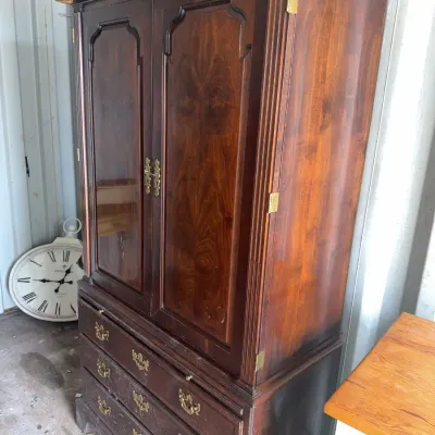 Sale Photo Thumbnail #98: Traditional dark wood armoire or entertainment cabinet, featuring rich Flame mahogany style veneer panels and brass hardware over three lower drawers.