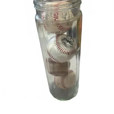 Sale Photo Thumbnail #268: Tall, clear glass jar filled with four vintage baseballs, including printed signature memorabilia balls.
