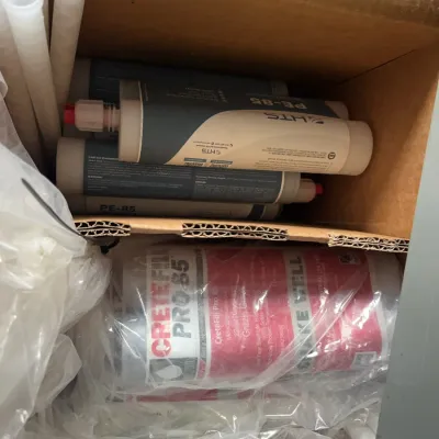 Sale Photo Thumbnail #20: Box filled with CreteFill Pro 85 polyurea joint filler cartridges and static mixing nozzles.