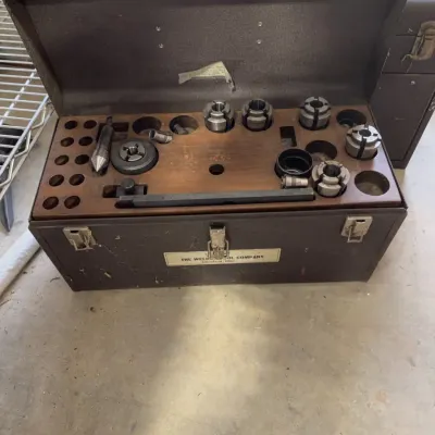 Sale Photo Thumbnail #234: Vintage metal tool storage box by The Weldon Tool Company, featuring a wooden insert organized with collets and machining accessories.
