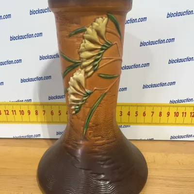 Sale Photo Thumbnail #121: Roseville Pottery Freesia vase in brown, measuring approximately 8 inches tall.