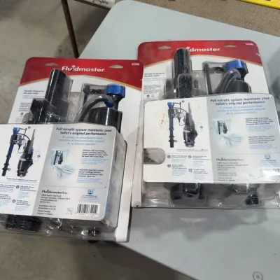Sale Photo Thumbnail #191: Two Fluidmaster full retrofit toilet fill valve systems in original blister packaging.
