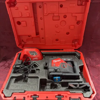 Sale Photo Thumbnail #9: Milwaukee M12 green 360-degree 3-plane laser level kit, complete with battery charger and accessories in a hard red carrying case.