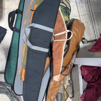 Sale Photo Thumbnail #59: Collection of assorted soft-sided gun and rifle carrying cases in various materials, colors, and styles.