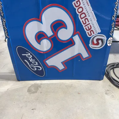 Sale Photo Thumbnail #54: Blue Ford race car hood panel featuring the number 13 and sponsor decals.