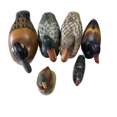 Sale Photo Thumbnail #279: Collection of six hand-painted carved wooden duck decoys and figurines in various sizes and species designs.