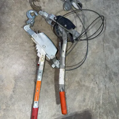 Sale Photo Thumbnail #94: Pair of heavy-duty ratcheting cable puller come along hoists with hooks and steel cables.