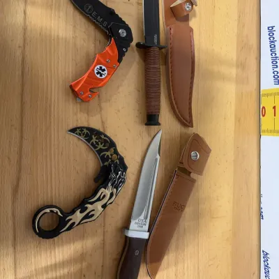 Sale Photo Thumbnail #147: Collection of four modern specialty and tactical knives, including an EMS pocket knife, a karambit, and two fixed-blade knives with leather sheaths.