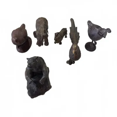Sale Photo Thumbnail #271: Collection of vintage dark metal and cast iron animal figurines, including birds, a bear, an elephant, and a lion.