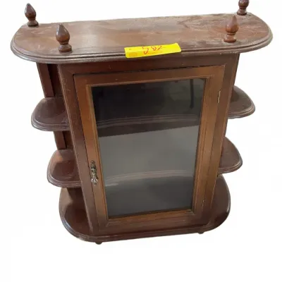 Sale Photo Thumbnail #259: Vintage dark wood tabletop display cabinet featuring a center glass-door compartment, tiered side shelves, and decorative top finials.