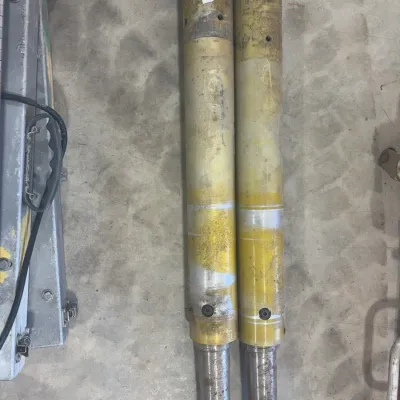 Sale Photo Thumbnail #71: Pair of heavy-duty industrial brass or steel extensions with threaded ends, showing surface wear from prior use.