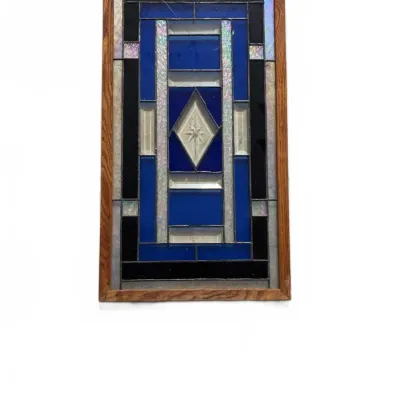 Sale Photo Thumbnail #110: Rectangular stained glass suncatcher panel with cobalt blue, clear bevels, and iridescent accents in a wooden frame.