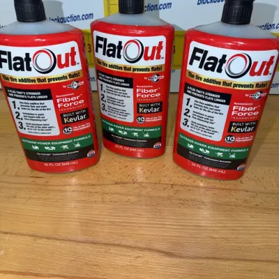 Sale Photo Thumbnail #195: Three 32 fl oz bottles of FlatOut tire sealant additive, designed for outdoor power equipment.