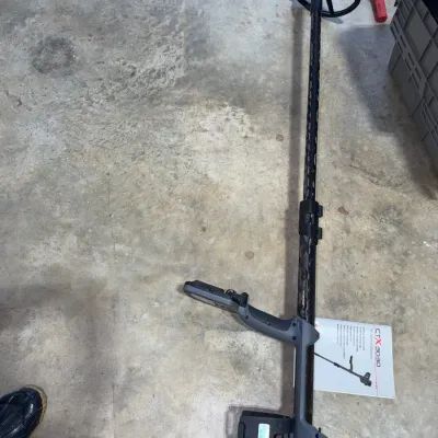 Sale Photo Thumbnail #93: Minelab CTX 3030 metal detector with search coil and instruction manual, lying on a concrete floor in gently used condition.