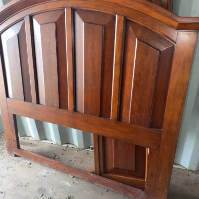 Sale Photo Thumbnail #101: Traditional arched wooden headboard with raised panel design and warm amber finish.