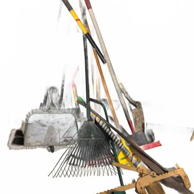 Sale Photo Thumbnail #117: Assorted collection of vintage lawn, garden, and maintenance tools including rakes, shovels, brooms, and a hand saw.