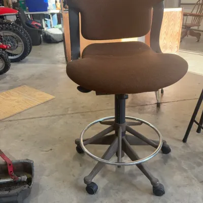 Sale Photo Thumbnail #78: Vintage brown fabric drafting stool with a chrome foot ring and a five-star wheeled base.
