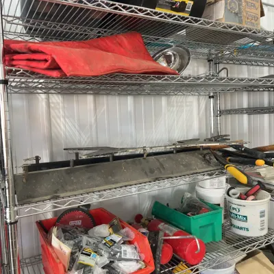 Sale Photo Thumbnail #30: Wire shelving unit organized with various workshop supplies, hardware, plastic storage bins, and tools.