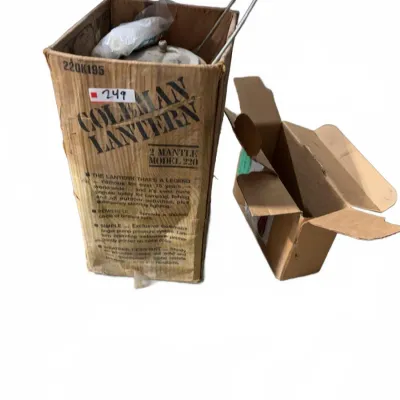 Sale Photo Thumbnail #116: Vintage Coleman Model 220 2-mantle lantern in its original cardboard box, alongside an additional small empty cardboard box.