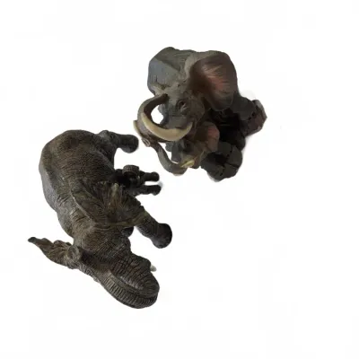 Sale Photo Thumbnail #264: Pair of molded resin elephant figurines with textured hide details and ivory-colored tusks.