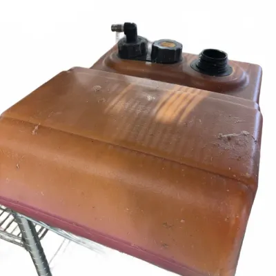 Sale Photo Thumbnail #232: Vintage translucent amber plastic boat fuel tank featuring black caps and a fuel gauge fitting, showing typical dust and wear.