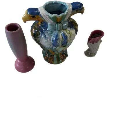 Sale Photo Thumbnail #301: Group of three vintage ceramic vases, featuring a colorful majolica-style double eagle head vase alongside two smaller decorative vases.