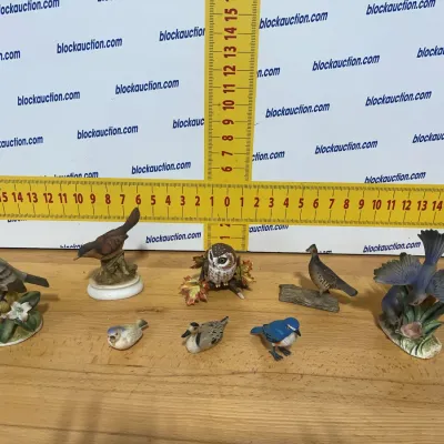 Sale Photo Thumbnail #143: Collection of eight small vintage bird figurines, including songbirds and an owl in various poses.