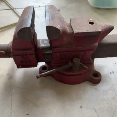 Sale Photo Thumbnail #246: Desmond-Simplex No. 350 heavy-duty bench vise with swivel base, showing surface rust and signs of age.