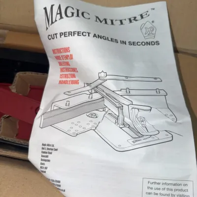 Sale Photo Thumbnail #192: Instruction manual for a Magic Mitre angle cutting tool, sitting inside an open cardboard box.