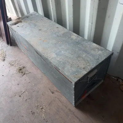 Sale Photo Thumbnail #102: Large vintage galvanized metal storage trunk with side handles, showing surface wear and patina.