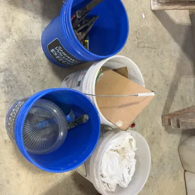 Sale Photo Thumbnail #48: Four plastic 5-gallon utility buckets containing various workshop supplies, hand tools, and shop rags.