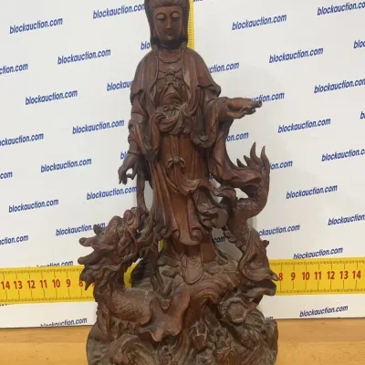 Sale Photo Thumbnail #138: Hand-carved wooden statue depicting Guanyin standing atop a detailed dragon amidst swirling waves, featuring intricate drapery and fine craftsmanship.