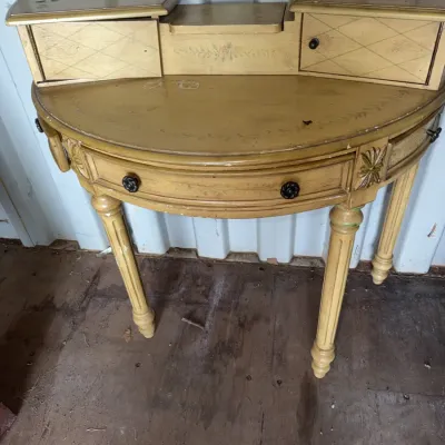 Sale Photo Thumbnail #100: French Neoclassical style demilune writing desk with distressed yellow paint finish, floral stenciling, and raised upper drawers.