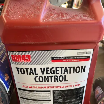 Sale Photo Thumbnail #39: Large red plastic jug of RM43 Total Vegetation Control herbicide concentrate containing 43.68% glyphosate with weed preventer.