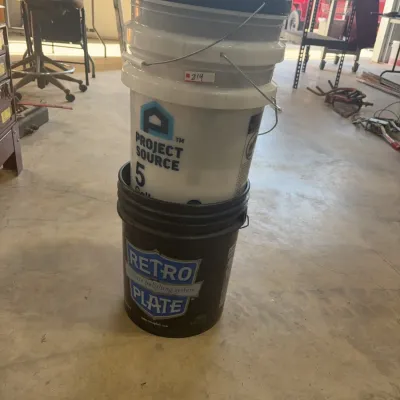 Sale Photo Thumbnail #75: Stack of plastic 5-gallon buckets featuring Project Source and Retro Plate branding with wire handles, in used condition.