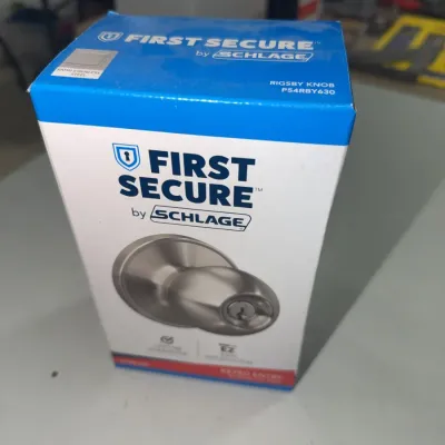 Sale Photo Thumbnail #194: First Secure by Schlage Rigsby door knob in satin stainless steel, brand new in original retail packaging.