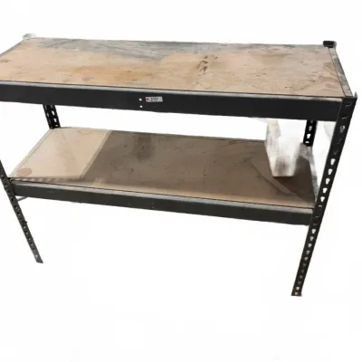 Sale Photo Thumbnail #115: Heavy-duty two-tier industrial workbench with a black metal frame and wood composition shelves showing signs of wear and surface staining.