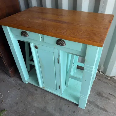 Sale Photo Thumbnail #97: Rustic wooden kitchen island featuring a natural wood countertop, light turquoise painted base, two drawers with cup pulls, and a central storage cabinet.