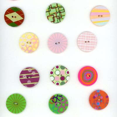 A CARD OF DIVISION THREE COLORFUL PLASTIC BUTTONS