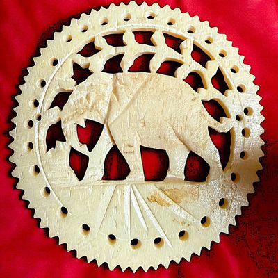 A DIVISION THREE PIERCED & CARVED ANIMAL BUTTON