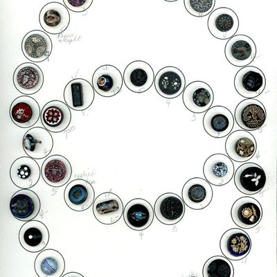 A CARD OF DIVISION ONE ASSORTED BLACK GLASS BUTTONS