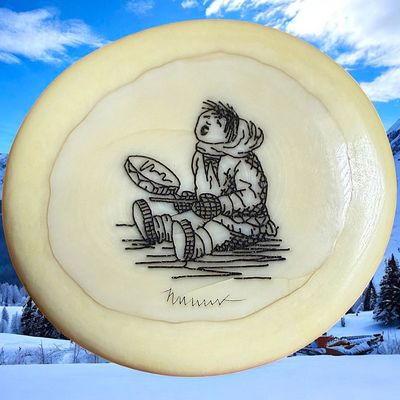 A DIVISION THREE ENGRAVED ESKIMO PICTORIAL BUTTON