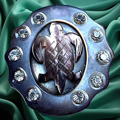 A DIVISION ONE CARVED PEARL AND PASTE ANIMAL BUTTON