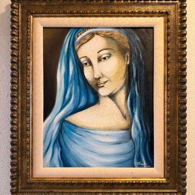Framed oil painting depicting a Madonna in a blue veil, signed and dated 2005. The artwork is presented in an ornate, gilded wooden frame...