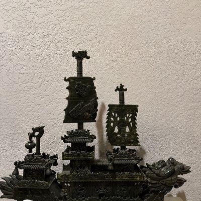 Intricately carved dark green jadeite Chinese dragon ship sculpture featuring detailed sails, pagodas, and a dragon head prow.